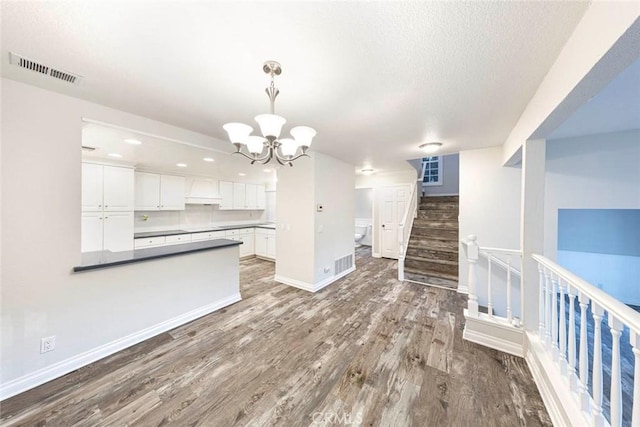 interior space with a notable chandelier and hardwood / wood-style flooring