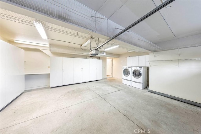 garage featuring a garage door opener and washer and clothes dryer