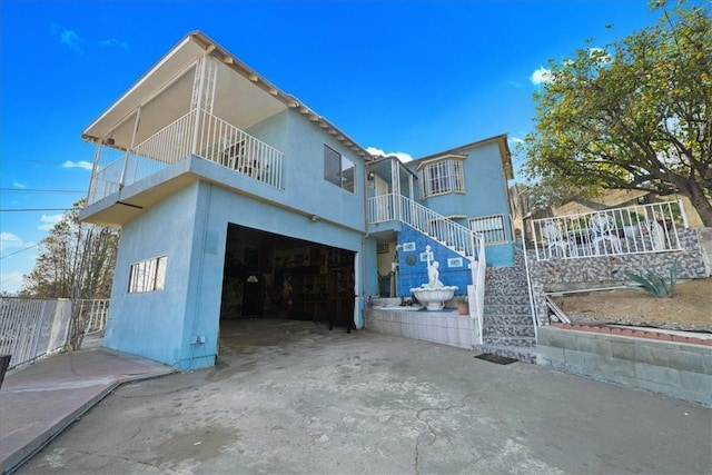 view of front facade with a balcony and a garage