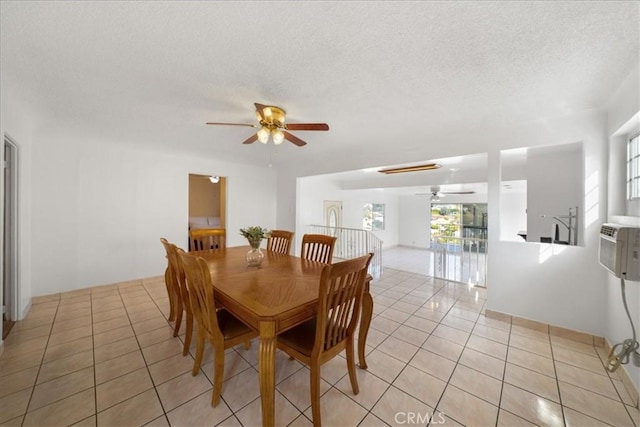 tiled dining room with a textured ceiling and ceiling fan