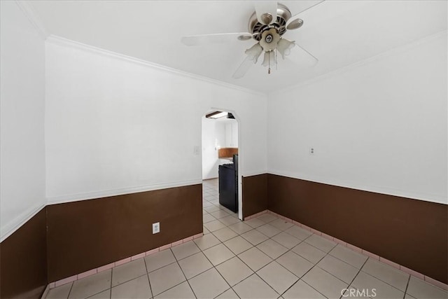 tiled spare room with ceiling fan and ornamental molding