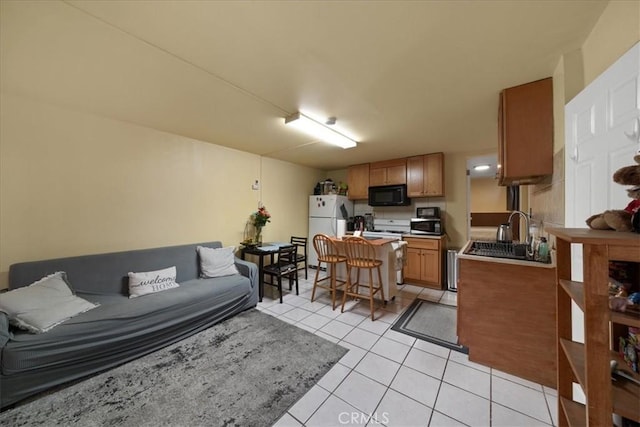 living room featuring sink and light tile patterned flooring