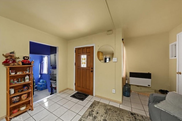 foyer with light tile patterned floors and heating unit