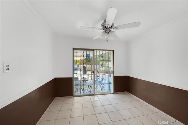 tiled spare room featuring ceiling fan