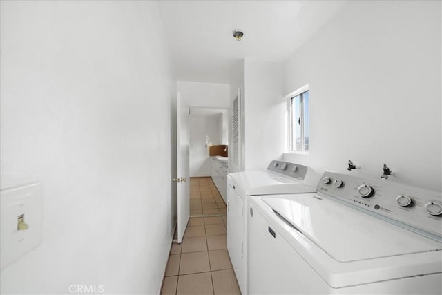 laundry room with light tile patterned floors and washing machine and dryer