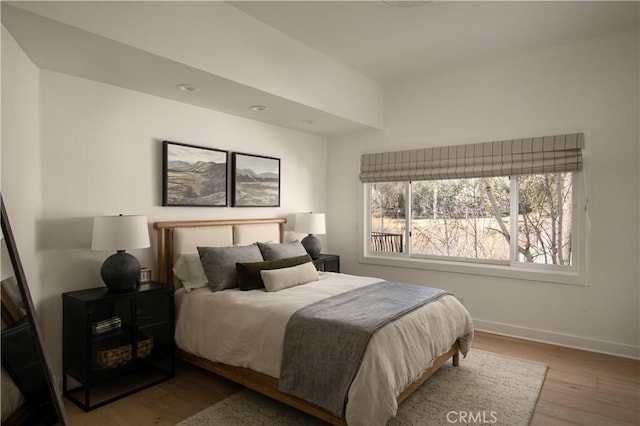 bedroom with hardwood / wood-style flooring