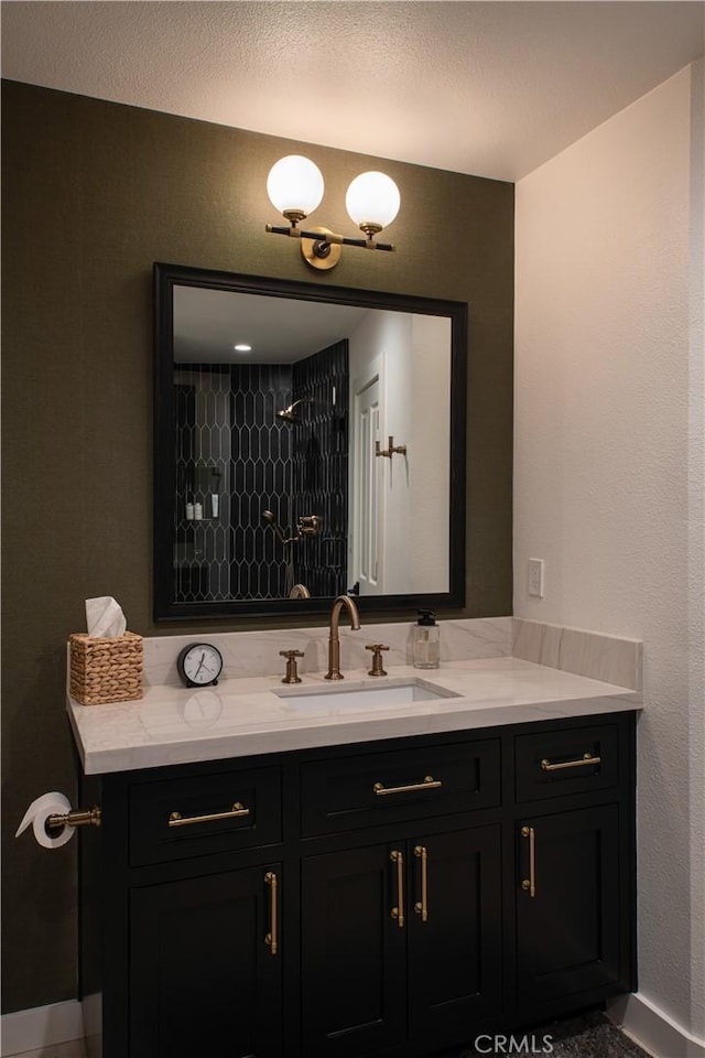 bathroom featuring walk in shower and vanity