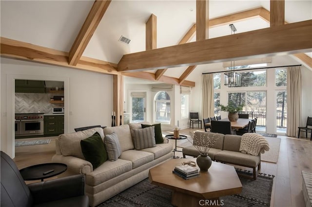 544 Golf Course Rd, Lake Arrowhead, CA 92352 - living room with high vaulted ceiling, beamed ceiling, a chandelier, and hardwood / wood-style flooring