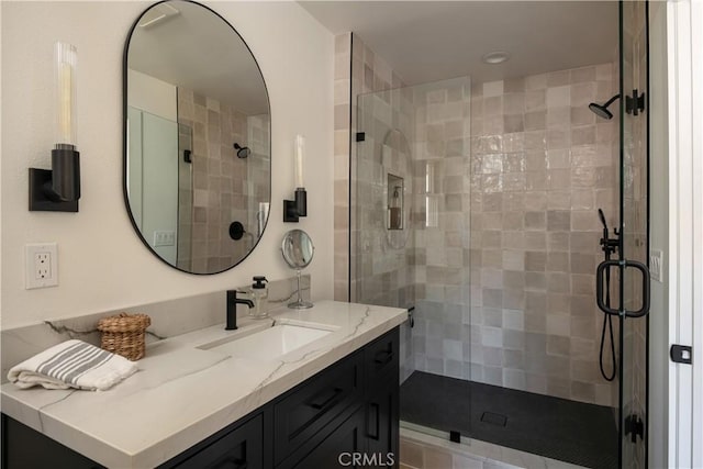 bathroom featuring an enclosed shower and vanity