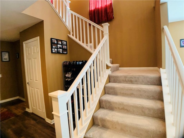 staircase with hardwood / wood-style floors