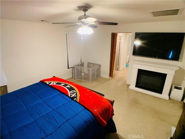 bedroom featuring ceiling fan and light carpet