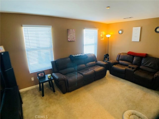 living room featuring plenty of natural light and carpet floors