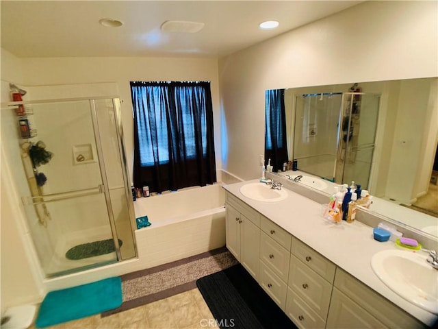 bathroom with vanity, plus walk in shower, and tile patterned flooring