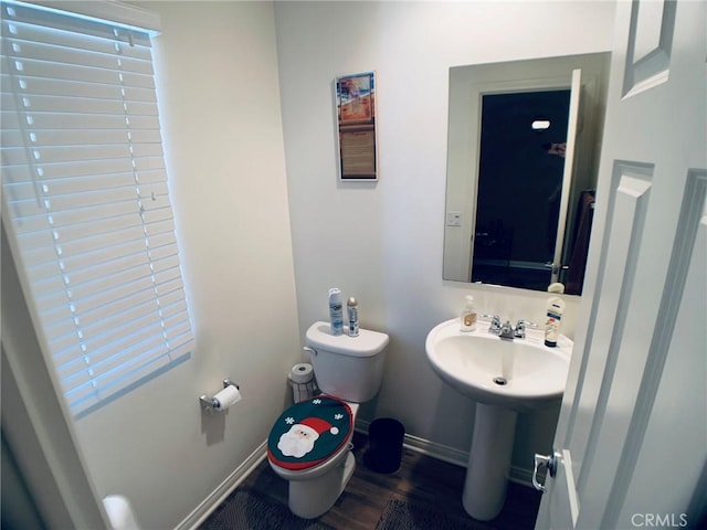 bathroom featuring sink, hardwood / wood-style floors, and toilet