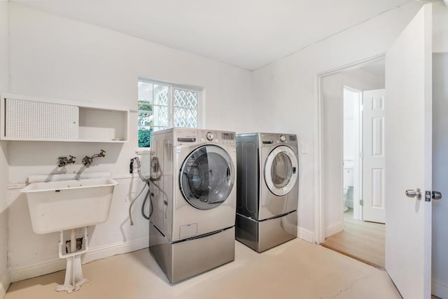 clothes washing area with washing machine and clothes dryer