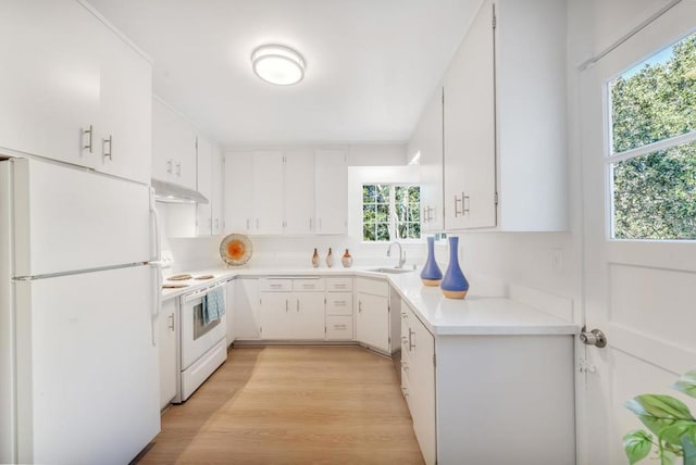 kitchen featuring white cabinetry, sink, white appliances, and light hardwood / wood-style flooring