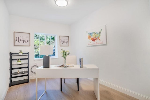 office with light hardwood / wood-style flooring