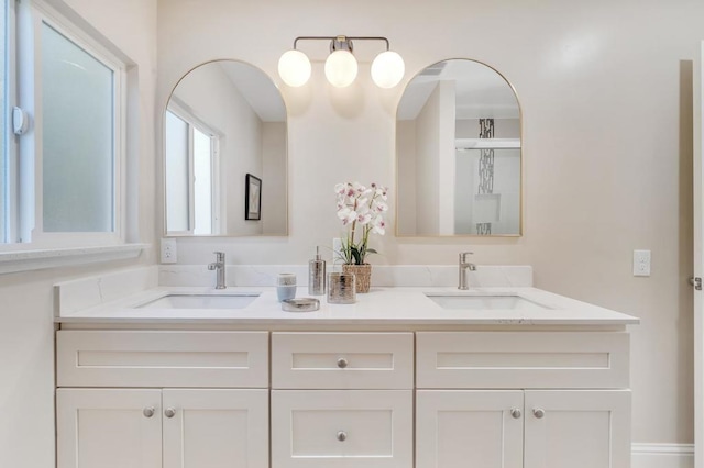 bathroom with vanity and a shower with shower door