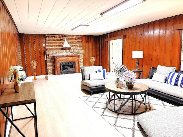 living room featuring hardwood / wood-style flooring, wooden ceiling, a fireplace, and wood walls