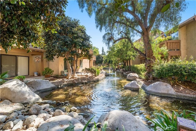 view of yard featuring a garden pond