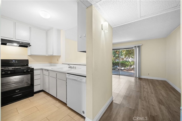 kitchen with black gas range oven, dishwasher, sink, and white cabinetry