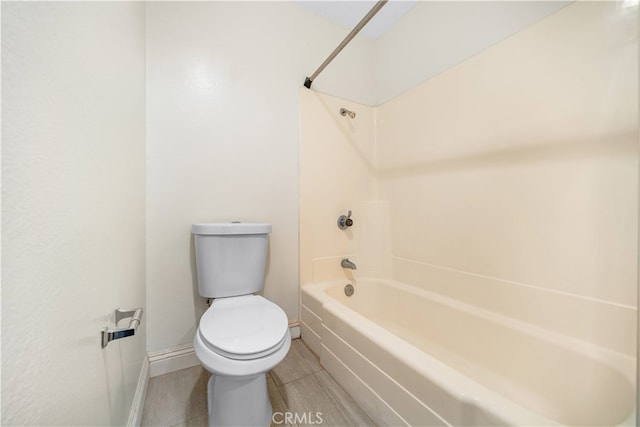 bathroom featuring shower / bathing tub combination and toilet