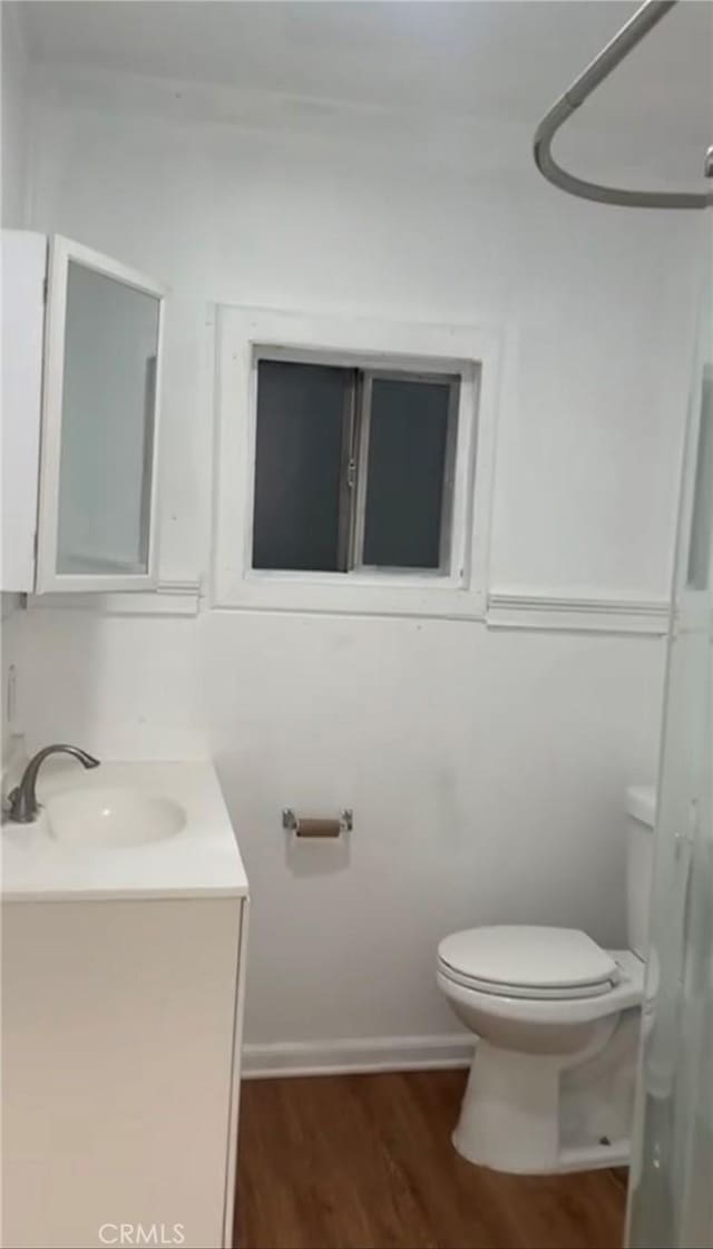 bathroom featuring hardwood / wood-style floors, toilet, and vanity