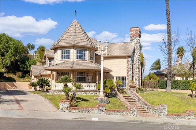 victorian house with covered porch and a front yard