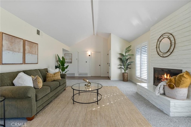 living room featuring a large fireplace, light carpet, and vaulted ceiling with beams