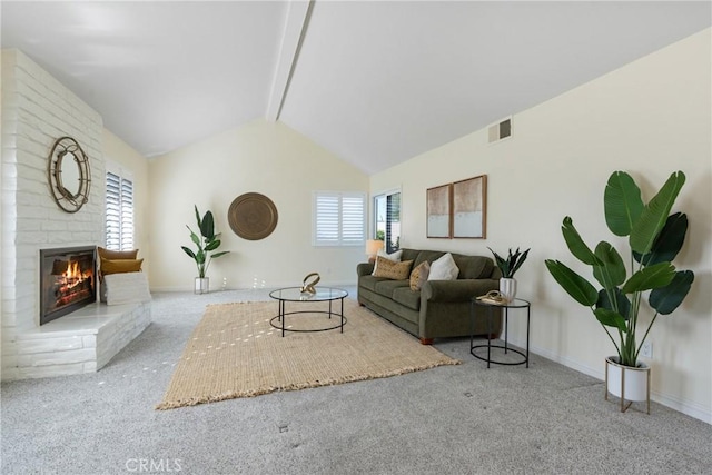 living room with light carpet, lofted ceiling with beams, and a fireplace