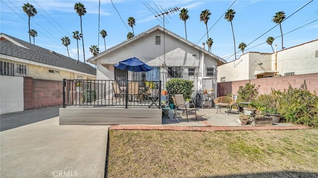 rear view of house with a yard and a patio