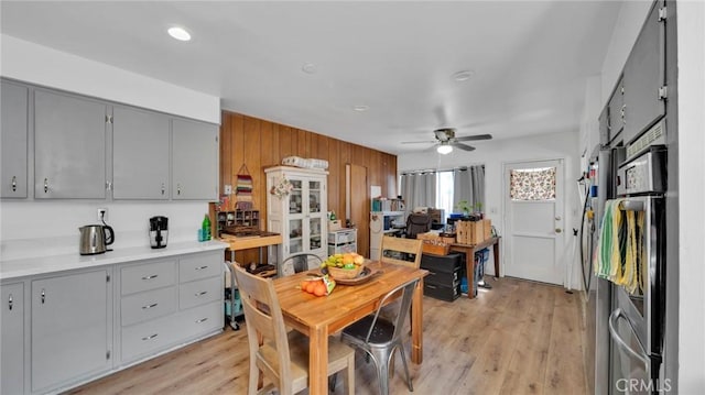 kitchen featuring ceiling fan, gray cabinets, and light wood-type flooring