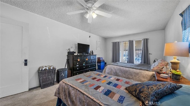 carpeted bedroom with ceiling fan and a textured ceiling