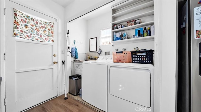 laundry room featuring washer and clothes dryer and dark hardwood / wood-style floors