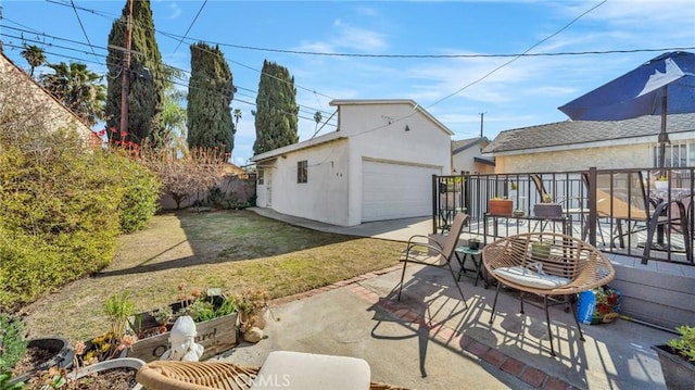 view of patio featuring a garage and an outdoor structure