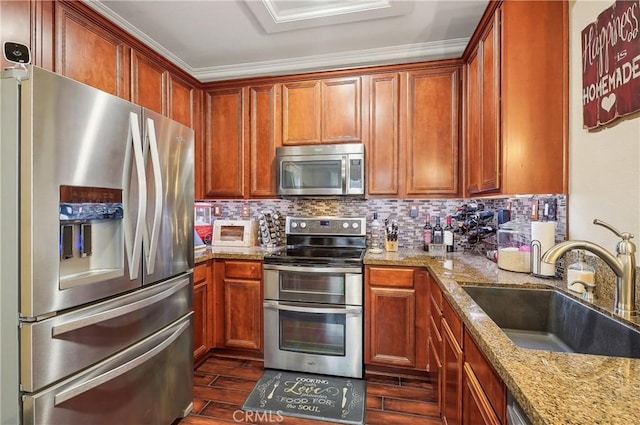 kitchen with stainless steel appliances, tasteful backsplash, light stone countertops, and sink