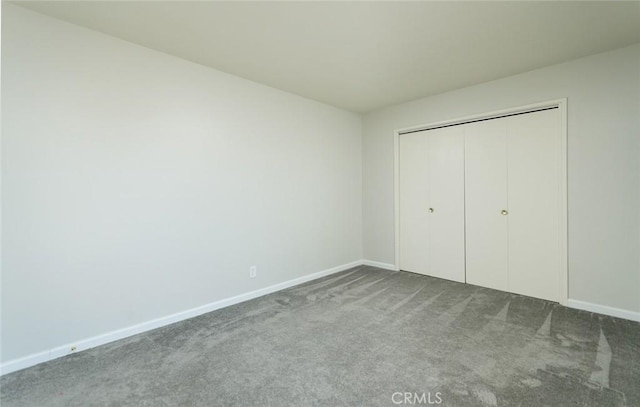 unfurnished bedroom with carpet and a closet