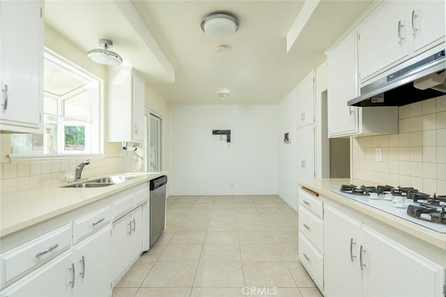 kitchen featuring white gas stovetop, dishwasher, light tile patterned floors, white cabinets, and sink