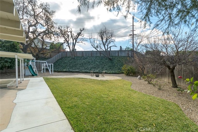 view of yard with a patio and a playground