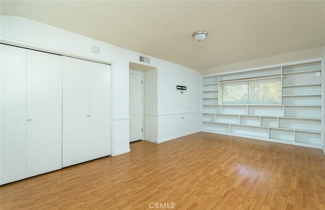 unfurnished bedroom featuring a closet and light hardwood / wood-style floors