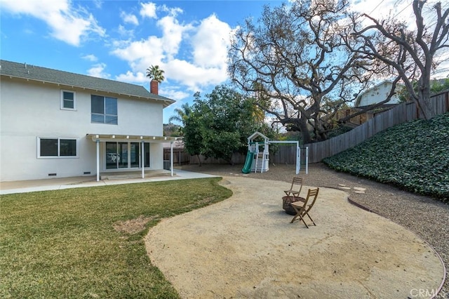 view of yard with a playground and a patio area