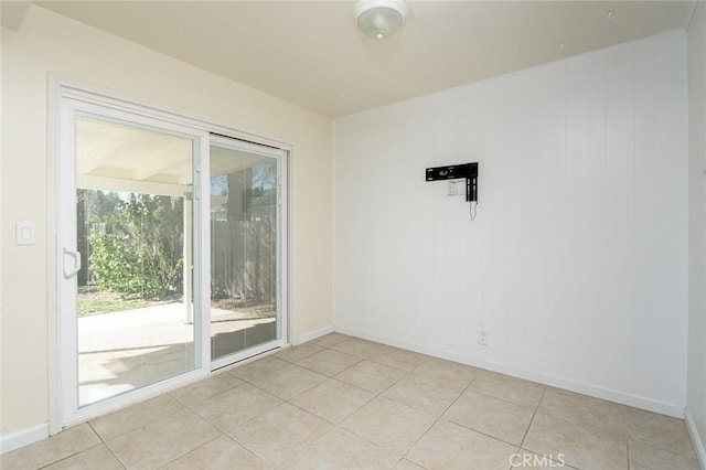 spare room featuring light tile patterned flooring