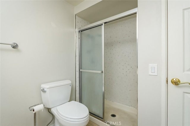 bathroom featuring toilet and walk in shower