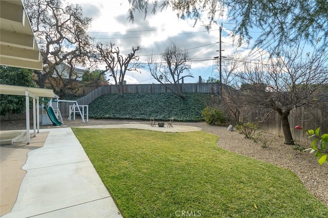 view of yard with a playground and a patio