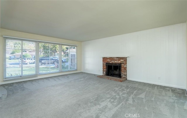 unfurnished living room featuring a brick fireplace and light colored carpet