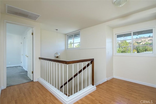 hallway with hardwood / wood-style flooring