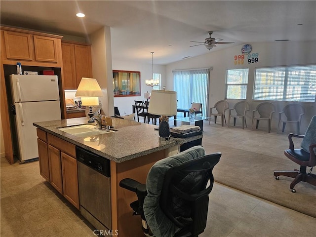 kitchen featuring white fridge, a center island with sink, lofted ceiling, dishwasher, and sink