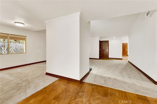 spare room featuring ornamental molding and wood-type flooring