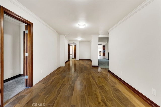 corridor with crown molding and dark hardwood / wood-style flooring