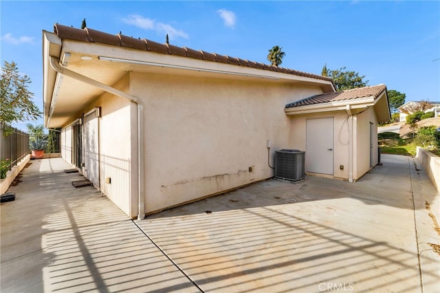 view of property exterior with a patio area and central air condition unit